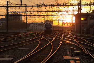 A train on the railroad tracks  during sunrise. Gare de Lyon-Perrache, Lyon, France.