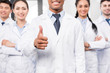 © LIGHTFIELD STUDIOS - Doctor with team showing thumb up