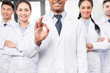 © LIGHTFIELD STUDIOS - Doctor with team showing ok sign