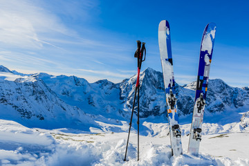 Fototapete - Ski in winter season, mountains and ski touring backcountry equipments on the top of snowy mountains in sunny day. South Tirol, Solda in Italy.
