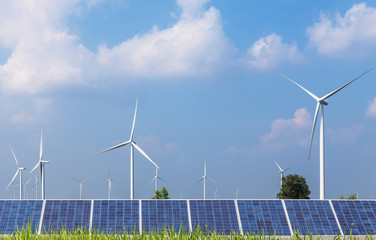 Wall Mural - solar cells with wind turbines generating electricity in hybrid power plant systems station on blue sky background alternative renewable energy from nature  Ecology concept.   