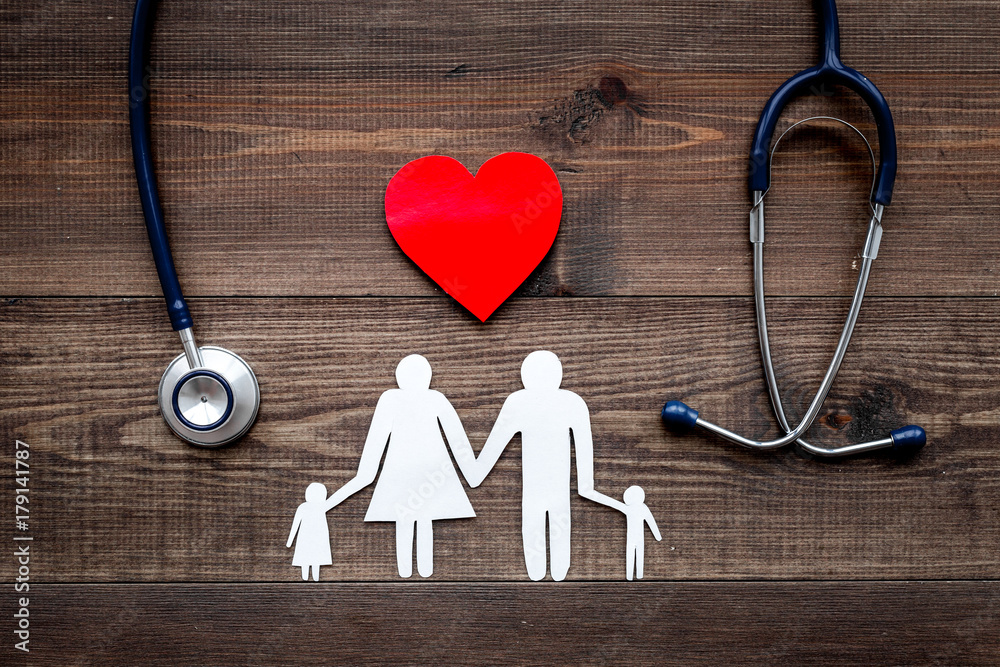 Take out health insurance for family. Stethoscope, paper heart and silhouette of family on wooden background top view - obrazy, fototapety, plakaty 