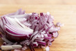 sliced red onion on a wooden board, close-up of the ingredient to healthy cooking, copy space,