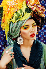 beauty bright woman with creative make up, many shawls on head l