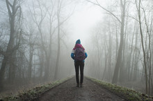 Girl With Bag Standing On The Road In The Foggy Morning