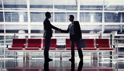 Business handshake in an airport