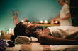 © Lumina/Stocksy - Woman relaxing on massage table at spa