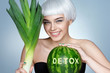 Smiling girl with green leek and watermelon. Photo of blonde girl on blue background. Detox concept