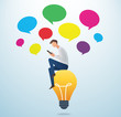 © santima.studio - man holding a smartphone sitting on the lightbulb with colorful could chat box