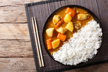 Wall Mural - Japanese curry rice with meat, carrot and potato close-up on a plate. horizontal top view