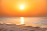 Fototapeta Zachód słońca - Sunset on the beach with long coastline, sun and dramatic sky 