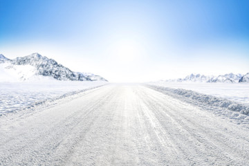 Wall Mural - winter background of foreground of road covered with snow and ice. in the background, the arctic lan