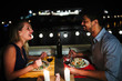 © NDABCREATIVITY - Young beautiful couple having romantic dinner on rooftop