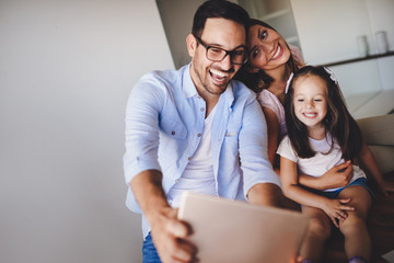 Wall Mural - Happy family taking selfie in their house