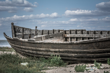Naklejka na meble An old wooden boat on the shore of the estuary in the village near the Black Sea
