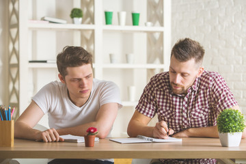 Canvas Print - Handsome businessmen doing paperwork front