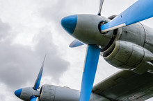 Close Up Of Airplane Turboprop Engine With Propeller, Parts Of Aircraft Fuselage, Wings And Tail On A Cloudy Sky Background
