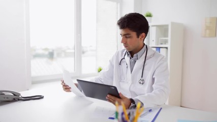 Poster - doctor with tablet pc and papers at hospital