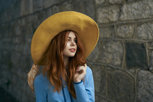 Woman Wearing Hat Near Stone Wall