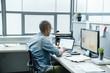 © FS Productions/Blend Images - Black businessman using laptop in office