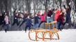 Children sled on snow stand