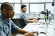 © FS Productions/Blend Images - Businessmen using technology in office