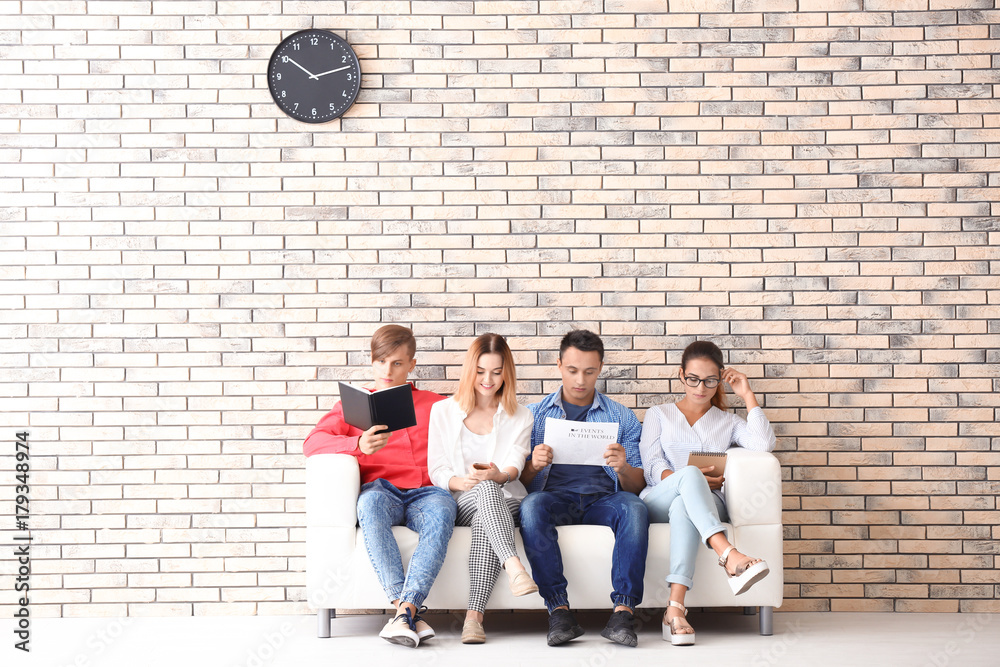 Group of people waiting for job interview on sofa
