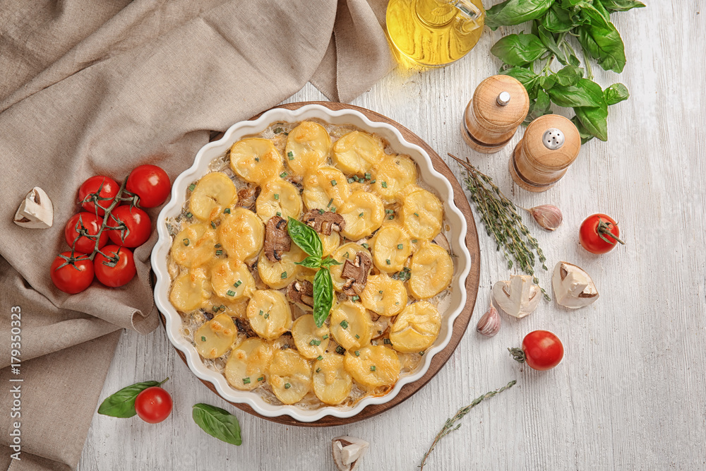 Baking dish with potato casserole on table