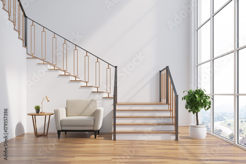 Fotografía White living room interior, stairs, armchair