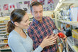 © auremar - Couple looking at kitchen blender in shop
