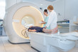 doctor preparing patient for mri scan in hospital