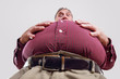 © soupstock - Man looking over his overweight stomach, letting out worn belt  (shallow focus)