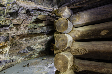 Abandoned old chromite mine shaft tunnel with wooden timbering