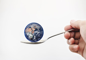 blue planet earth on spoon, isolated on white background. elements of this image is furnished by nas