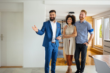 young couple looking new home with agent