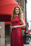 Fototapeta Londyn - Beautiful elegant woman in a red dress on the street