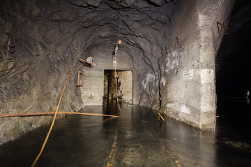 Underground mine shaft iron ore tunnel gallery with flooded water