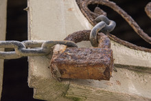 Rusty Padlock & Chain. Holding Together Shutter With Rusted Filigree Detail