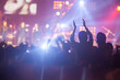 © suwanphoto - blurry image background of many audience concert in big rock concert.