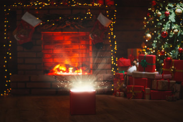 Wall Mural - magic christmas present at the christmas tree and fireplace.