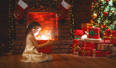 Wall Mural - child girl with magic gift on christmas eve