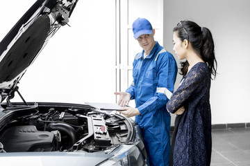 Wall Mural - Young mechanic giving repair cost to his client