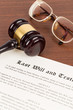 © wirojsid - Last will and testament on yellowish paper with wooden judge gavel; document is mock-up