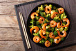 Stir frying shrimp with broccoli closeup. Horizontal top view