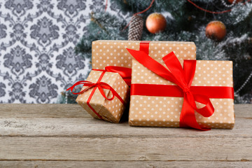 Wall Mural - Christmas presents on decorated tree background, holiday concept