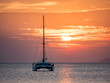 Sailing Boat and Catamaran at Sunset