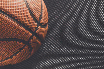 Old basketball ball on black background copy space