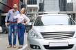 © Africa Studio - Young couple standing near car outdoors