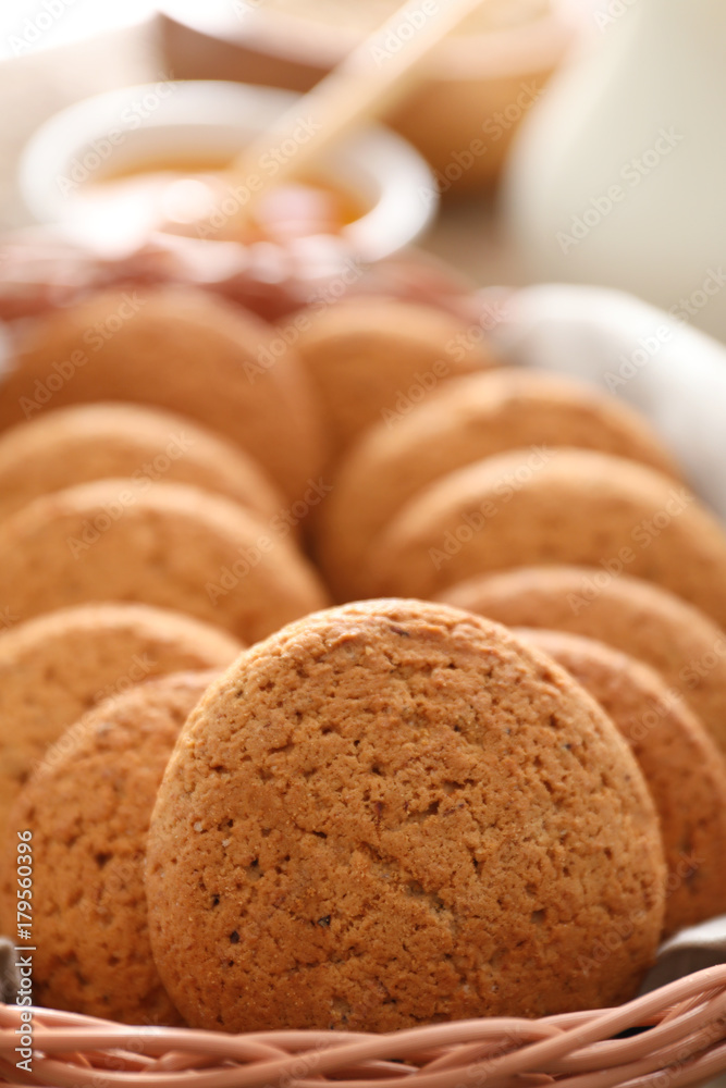 Wicker basket with delicious oatmeal cookies, closeup