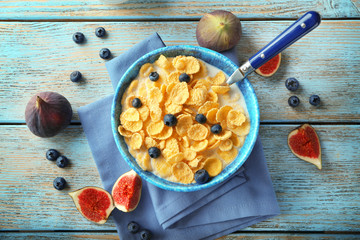 Canvas Print - Dish with cornflakes and milk on table